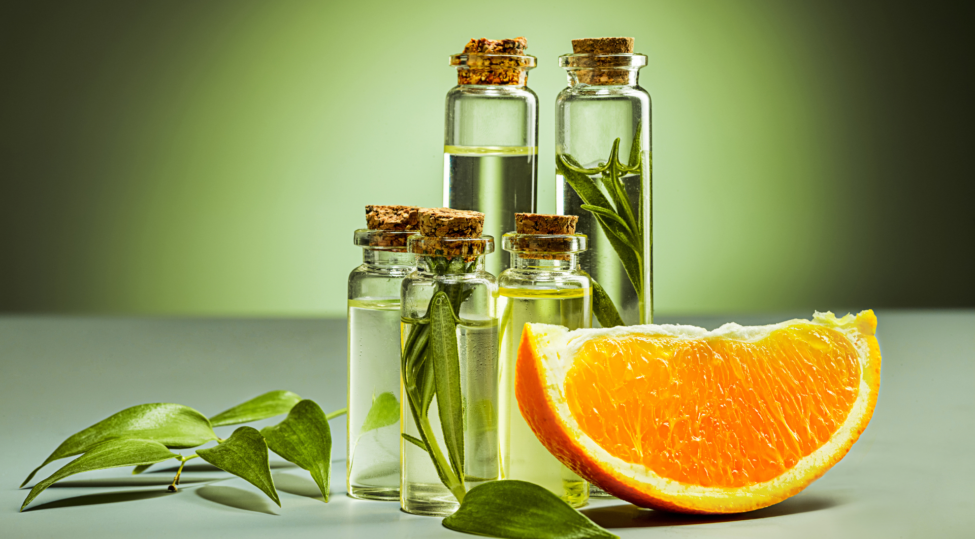 Glass vials with botanical liquid and orange slice representing natural phytosterol ingredients